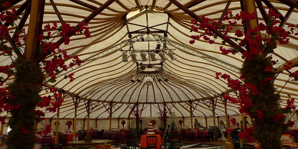 Bespoke marquee lining with timber lattice roof and floral garlands