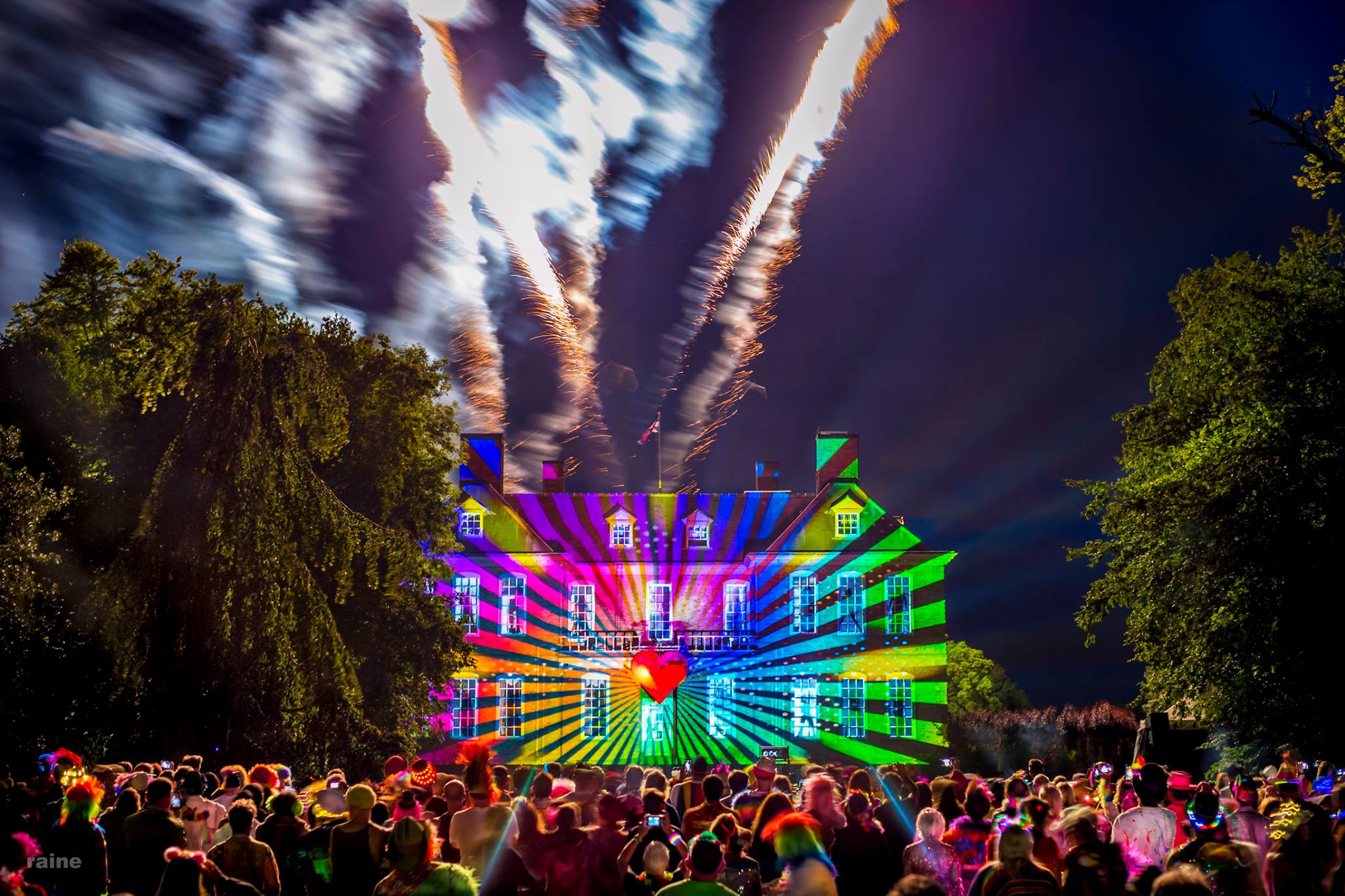 Fireworks over a projection-lit manor house